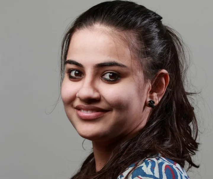 Portrait of a smiling young woman representing the persona Aarti Sharma.